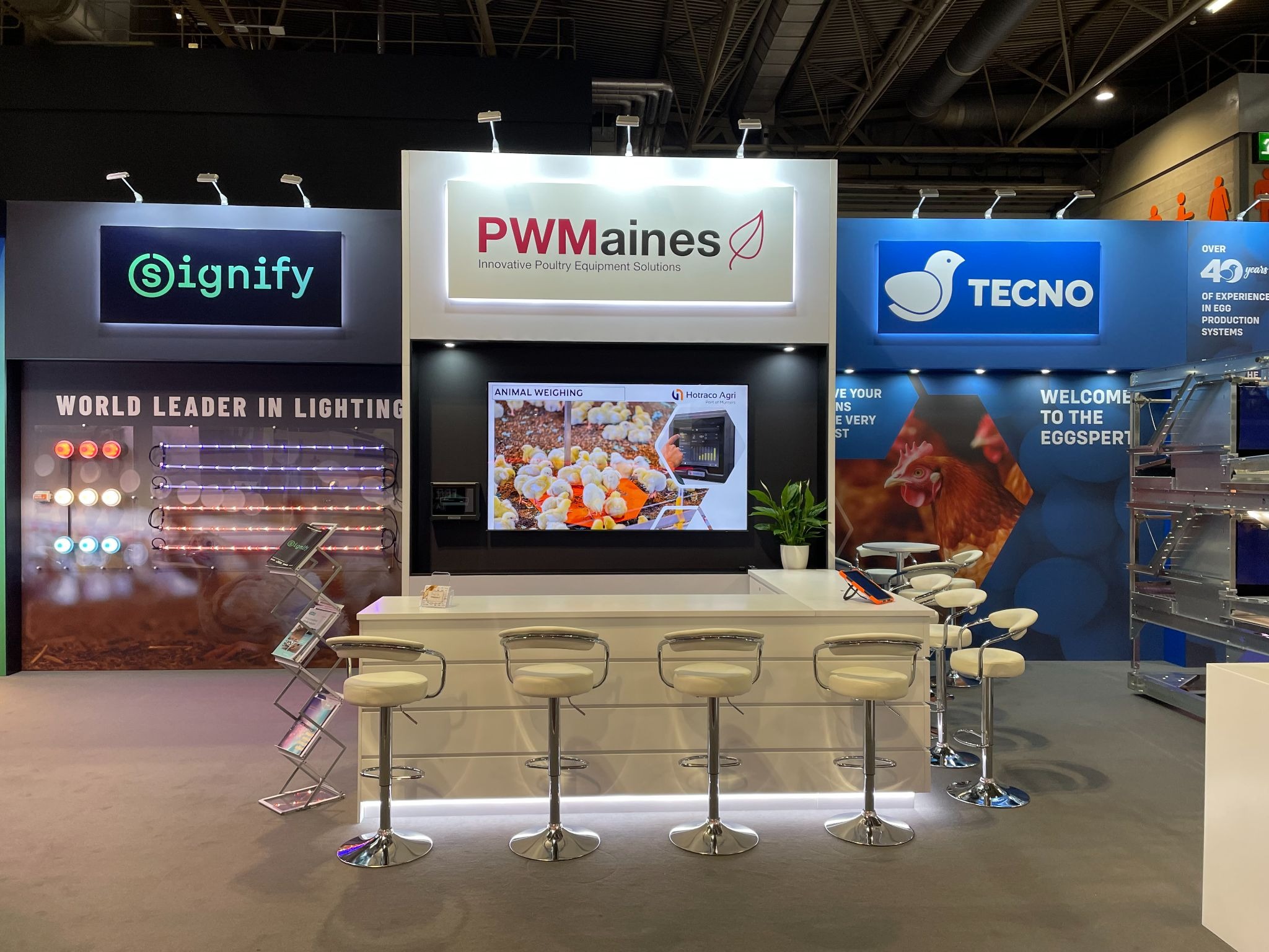 PW Maines displaying advanced Poultry Housing equipment, poultry lighting systems, and ventilation technology at an agricultural industry exhibition.