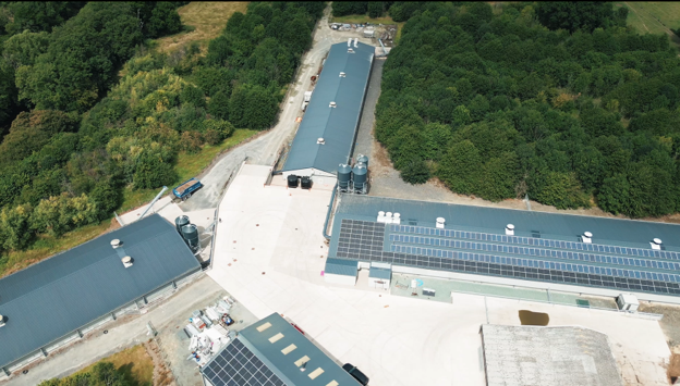 An aerial view of poultry houses fitted with poultry house ventilation systems and solar panels.